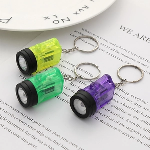 Vibrant LED flashlight keychains in yellow, green, and purple with metallic rings