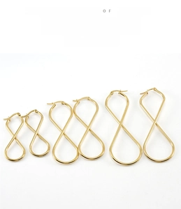 Three pairs of gold twisted hoop earrings in teardrop shapes ranging from small to large