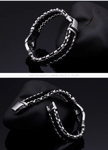 Detailed macro view of men's multi-layer woven bracelet with engraved vintage metal clasp