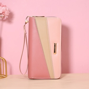 Detailed view of women's long wallet with pink color-block design and gold trim