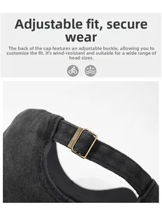 Close-up of the vintage bronze metal adjustable buckle on a dark grey cotton baseball cap