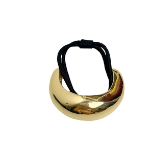 Minimalist golden arched metal hair tie with black elastic band for ponytail styling