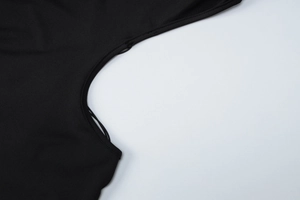 Close-up of the premium black backless dress featuring precise stitching and sleek fabric