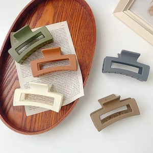 Morandi square resin hair claws set in assorted vintage colors on a wooden tray