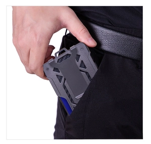 Slim carbon fiber tactical wallet with metal clip shown sliding into a pocket