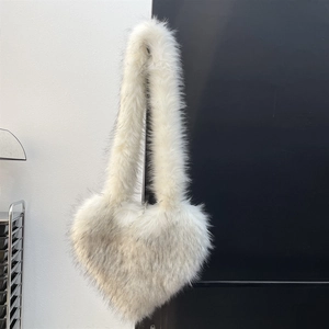 Detailed close-up of the plush heart-shaped bag with soft white faux fur and grey tips