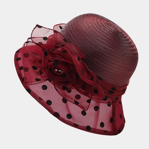 Detail of burgundy organza flower and black polka dot mesh on elegant summer sun hat