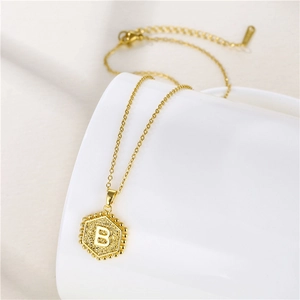 Gold hexagonal letter B necklace in matte finish with a minimalist stainless steel chain