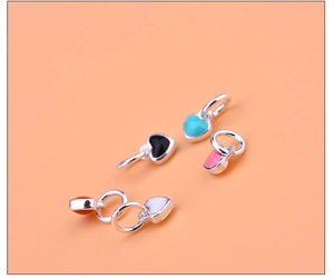 Detailed view of colorful heart-shaped charms in red, pink, blue, black and white finishes