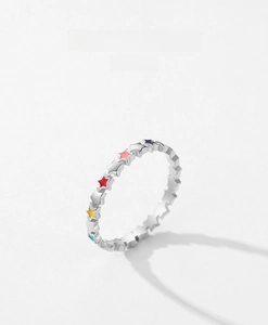 Detail of S925 silver ring featuring colorful enamel stars in blue and purple
