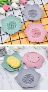 Detailed view of 3D lotus silicone soap dishes in pink, green, and grey with drainage holes