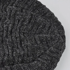 Detailed macro view of the thick chenille knit texture on a winter beanie hat