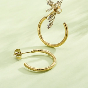 Minimalist gold-tone C-shaped twist earrings with spiral texture and butterfly backings