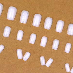 Minimalist white gradient press-on nails with pink glitter and polished resin finish