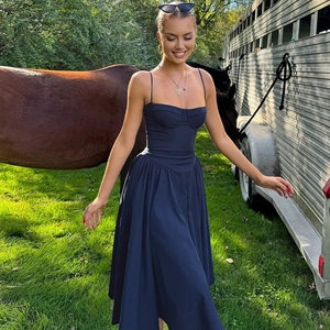 Close-up of navy blue sundress featuring corset waist and flared skirt detail