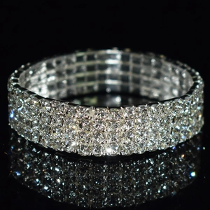 Macro shot of silver bridal bracelet featuring four rows of sparkling rhinestones