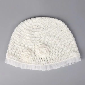 Detail of white crochet knit bucket hat with floral accents and sheer mesh trim