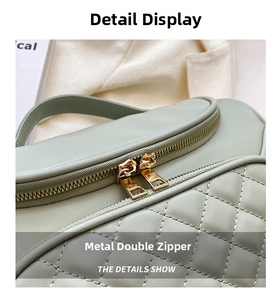 Light green quilted PU cosmetic bag detail showcasing elegant gold double zippers and carry handle.