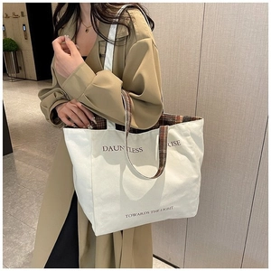 Minimalist beige canvas tote bag with plaid shoulder straps and letter print for women