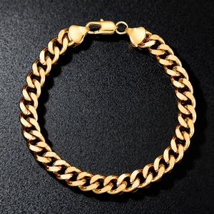 Polished golden stainless steel Cuban link bracelet in circular layout on black background