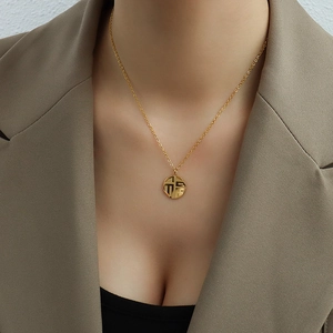 Golden titanium steel necklace with Fu character pendant worn on a model's neck