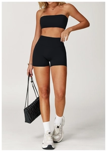 Detailed view of women's black matte athletic tube top and high-waist biker shorts set
