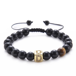 Detail of tiger eye and black onyx beaded bracelet with micro-pave zircon letter D bead