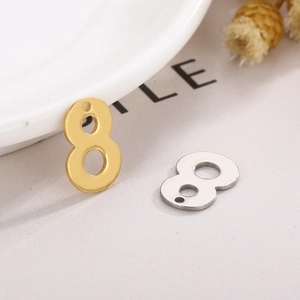 Macro shot of stainless steel number 8 pendants in gold and silver for DIY jewelry
