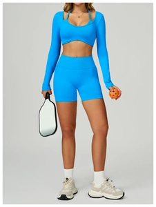 Detail of bright blue seamless two-piece yoga set with crop top and high-waisted shorts