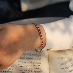 3mm Tennis Chain bracelet with red and white zircon stones in gold finish on a hand