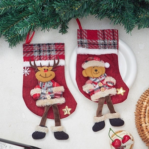 Detail of burlap Christmas stockings with 3D reindeer and bear dolls for holiday decor