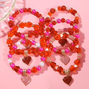 Close-up of red and pink heart beaded bracelets for Valentine gift with glitter charms