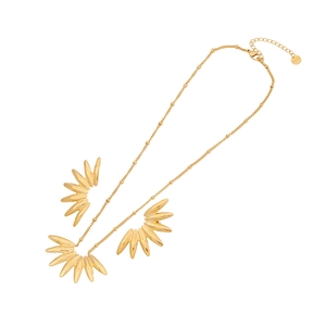 Irregular gold necklace with feather pendants and bead chain on white background