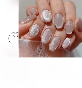 Detailed close-up of nude pink cat eye short square press-on nails with silver shimmer