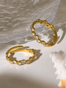 Detail of two adjustable 18K gold plated rings with bubble-set sparkling zircon stones