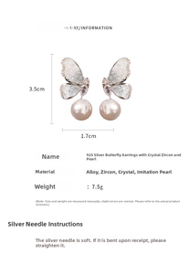 Detailed view of silver butterfly earrings with crystals, zircons and faux pearls