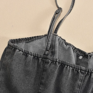 Detail of adjustable straps and elastic shirring on distressed charcoal denim dress