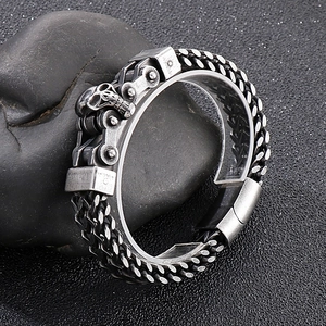 Detail view of gothic skull head link chain bracelet for men on black stone