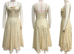 Detail of yellow floral sundress showing delicate lace hem and back zipper closure
