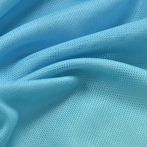 Macro detail of breathable light blue mesh fabric with soft textured draped folds