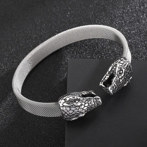 Detail of silver stainless steel mesh bracelet featuring dual textured snake heads