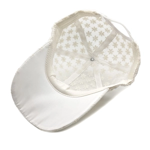 Detailed view of the white floral lace baseball cap with sheer mesh and neat stitching