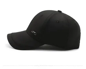 Side view of black cotton baseball cap with a rectangular silver metal side label