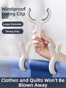 Close-up of white windproof large diameter clips securing a blanket with a strong grip