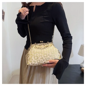 Detail of champagne gold sequin evening bag with leopard pattern and diamond clasp