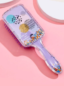 Detail of purple hairbrush with butterfly sequins and 'You are very beautiful today' text