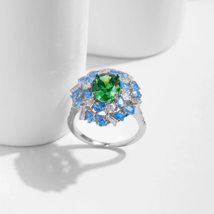 Vintage s925 silver ring featuring emerald cut green stone and blue halo gems