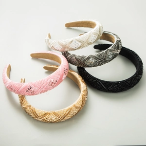 Close-up of five handmade beaded headbands with geometric patterns and sequins