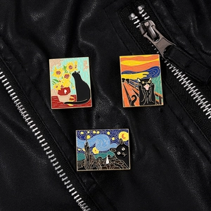 Artistic enamel cat pins featuring Sunflowers and Starry Night on a black leather jacket