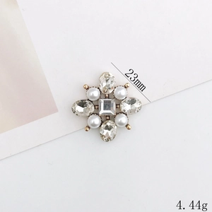 Macro shot of a 23mm floral pearl shoe charm with a square crystal and gold base